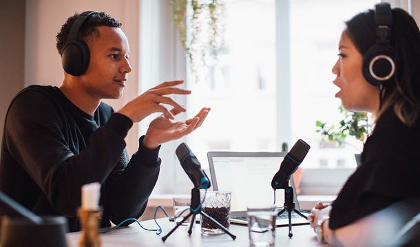  Boy and girl wearing headphones have a conversation over a microphone