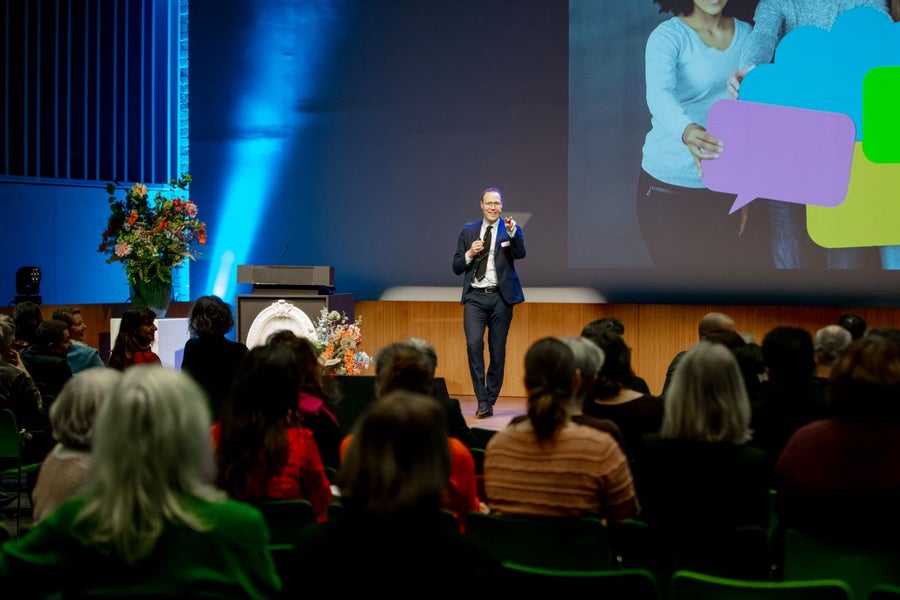 Host of the event welcomes the audience in auditorium