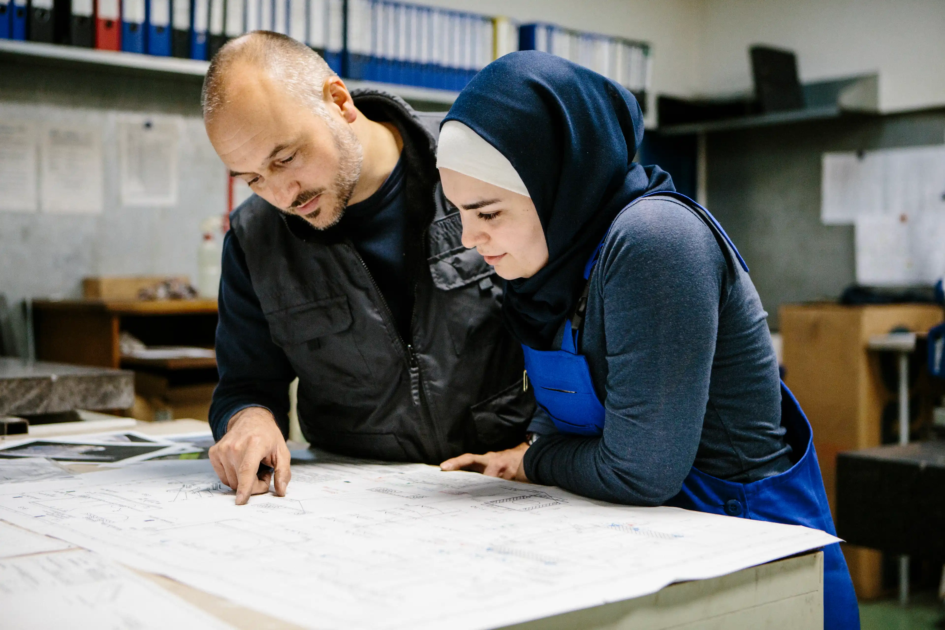 Two people looking at a diagram