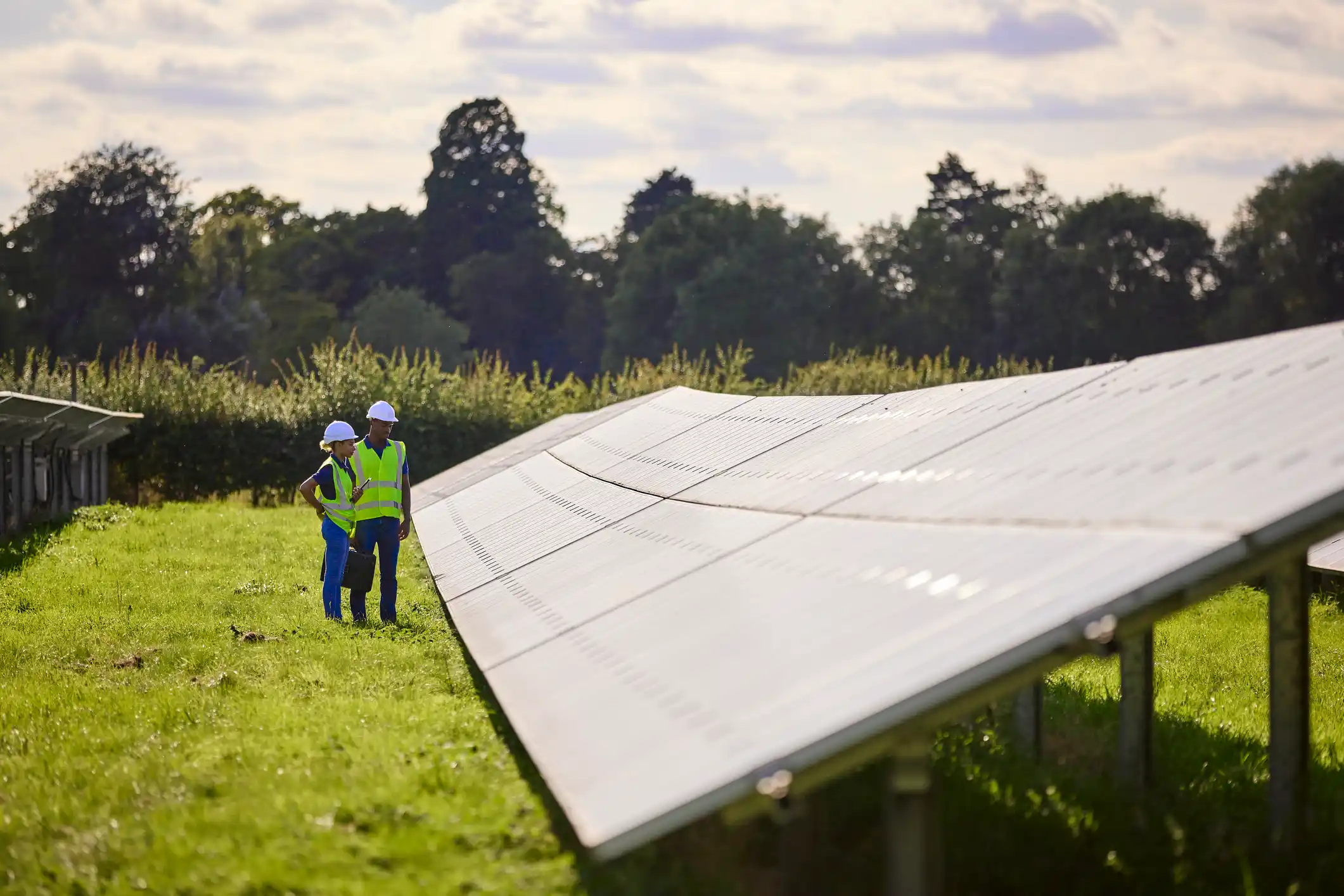 Two engineers look at a solar panel. 