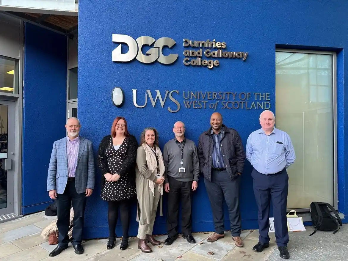 A group of colleagues stand outside UWS and Dumfries and Galloway College