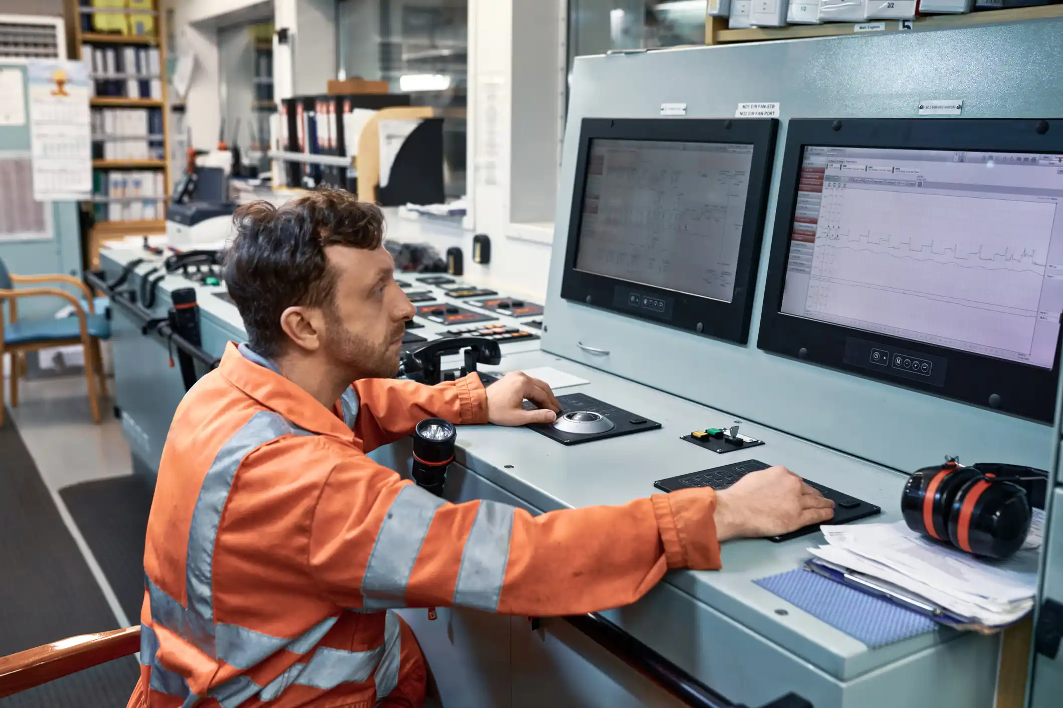 Engineer working on the engine control room console