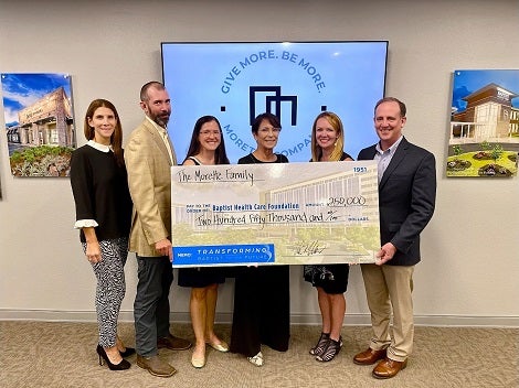 Morette family posing with big check