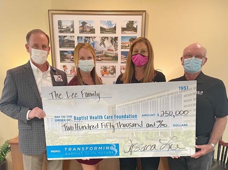 Lee family posing with big check