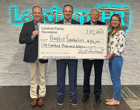 Mark Faulkner, Britt Landrum III, Britt Landrum Jr., and KC Gartman holding check