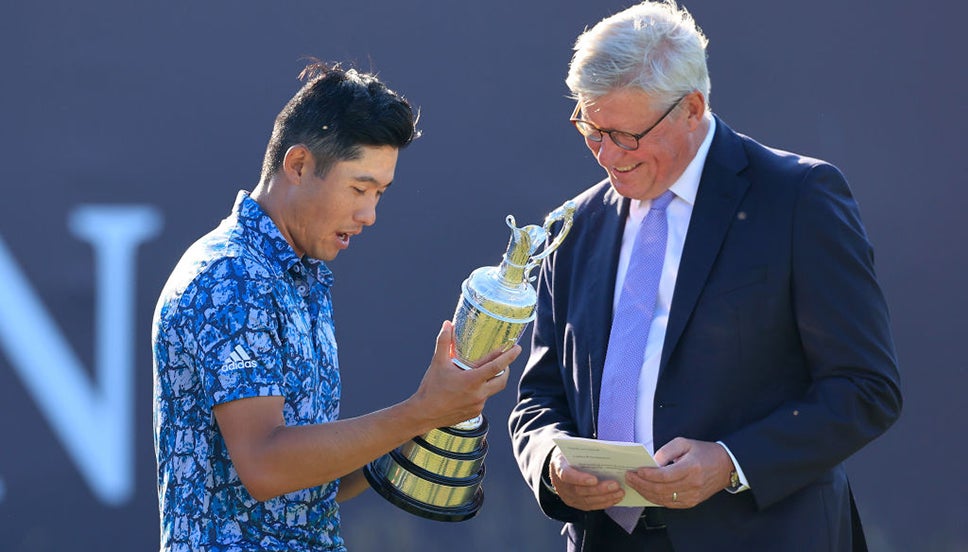 Collin Morikawa admires the Claret Jug alongside R&A Chief Executive Martin Slumbers