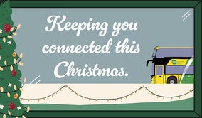 A drawing of a Christmas tree connected by Christmas lights to a green and yellow Bus Éireann bus called "keeping you connected this Christmas"