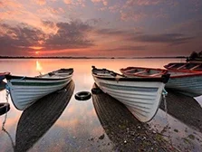 Colorful sunset with fishing boats in front on beautiful Lough Owel, Mullingar, Ireland.