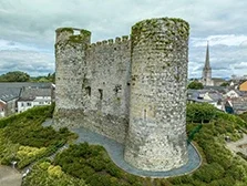 Aerial view of Carlow castle and town in Ireland with circular towers above the river Barrow