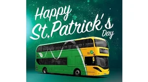A graphic design saying happy St. Patrick's Day. Below the text is a green and yellow Bus Éireann Bus