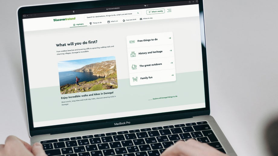 An individual is using viewing the different link options on the Discover Ireland homepage 