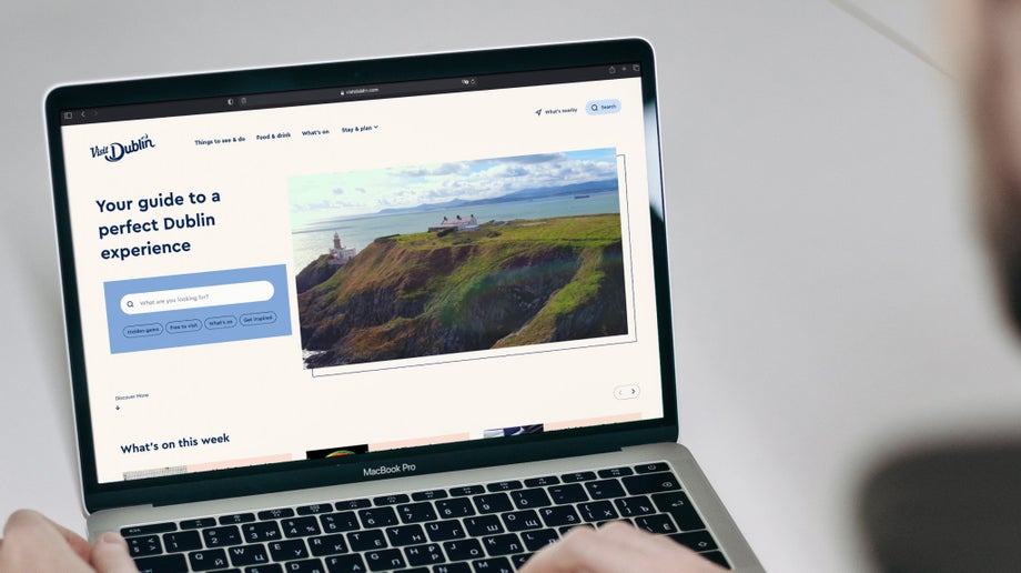 An individual is viewing visitdublin.com’s landing page on their laptop.