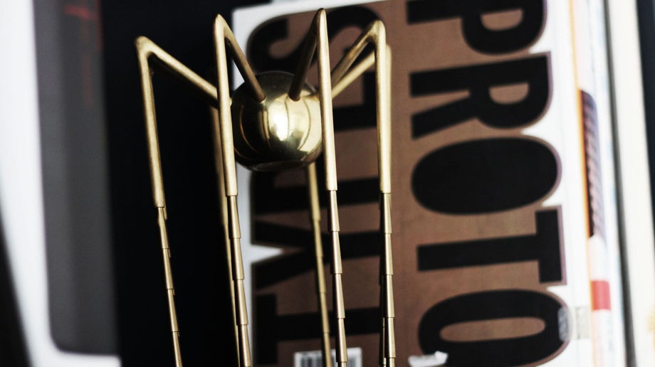 Spider Award on a shelf with design books in the background