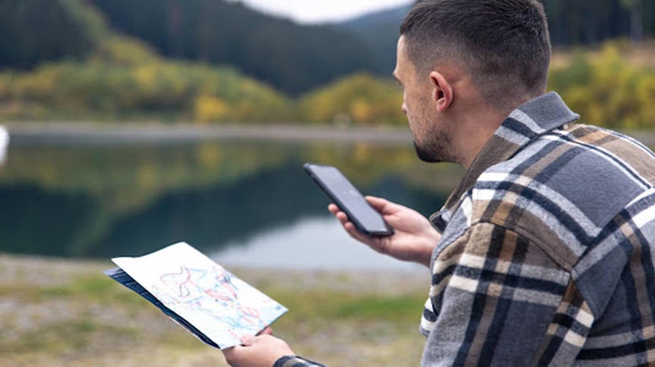Man holding map and mobile phone