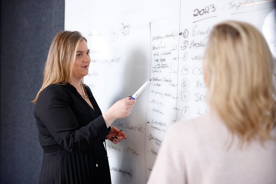 2 women at a whiteboard