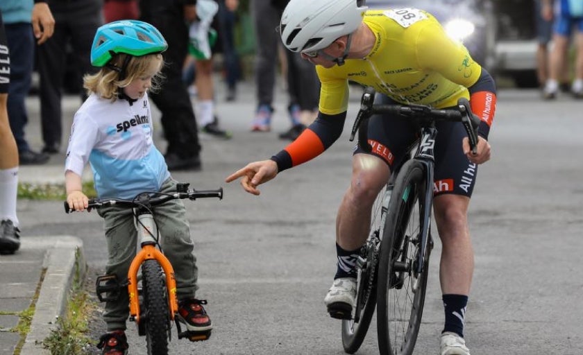 Daire Feeley interacting with a young child on his bike 