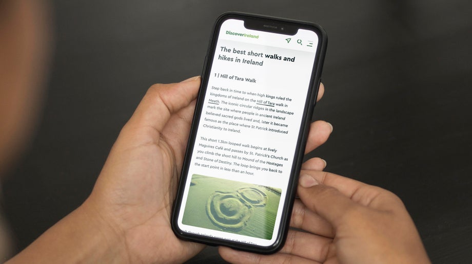An individual is reading an article on Discover Ireland that has a main heading and the reading content underneath.