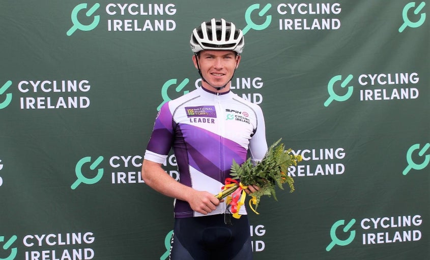Daire Feeley holding flowers on the podium 