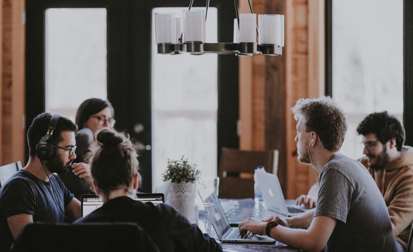 People working from laptops at a table