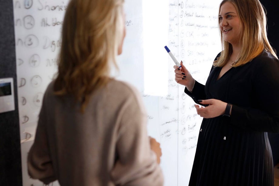 Two ladies having a discussion around UX