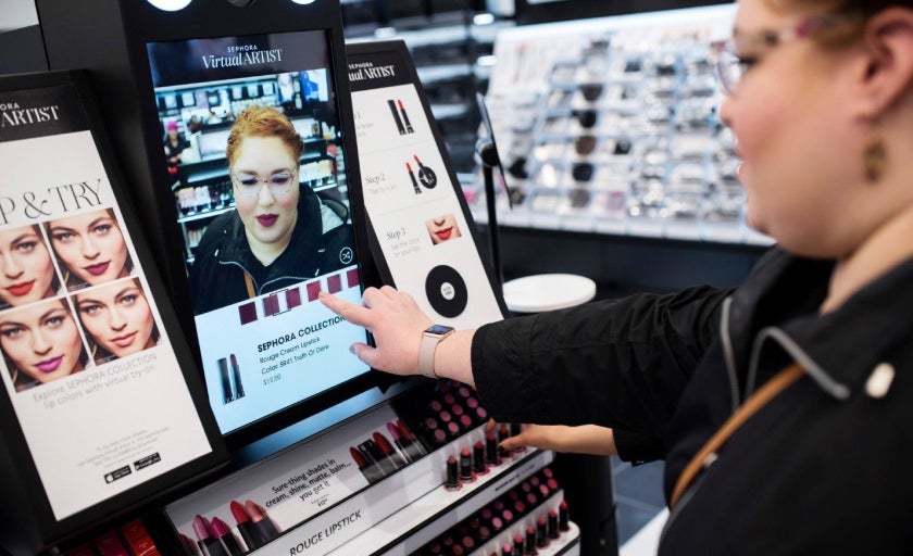 A person uses Sephora's in store try on feature on a tablet