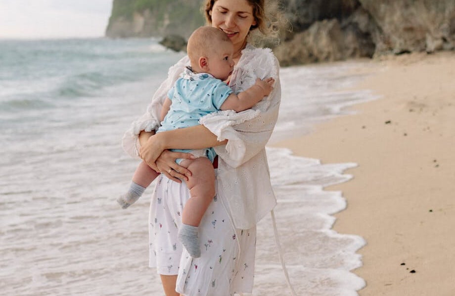 Woman with baby on a beach