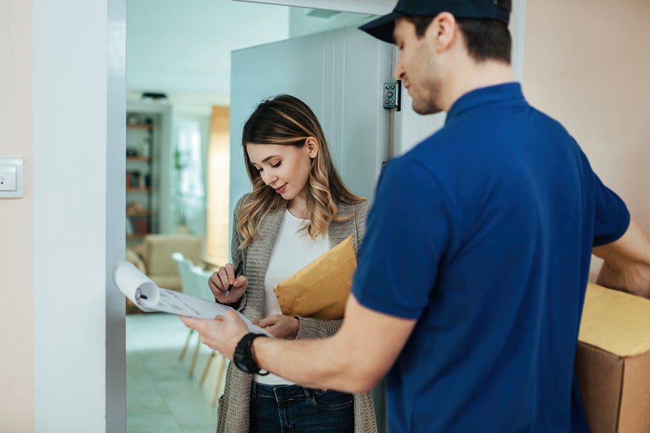 Delivery man handing over package to recipient