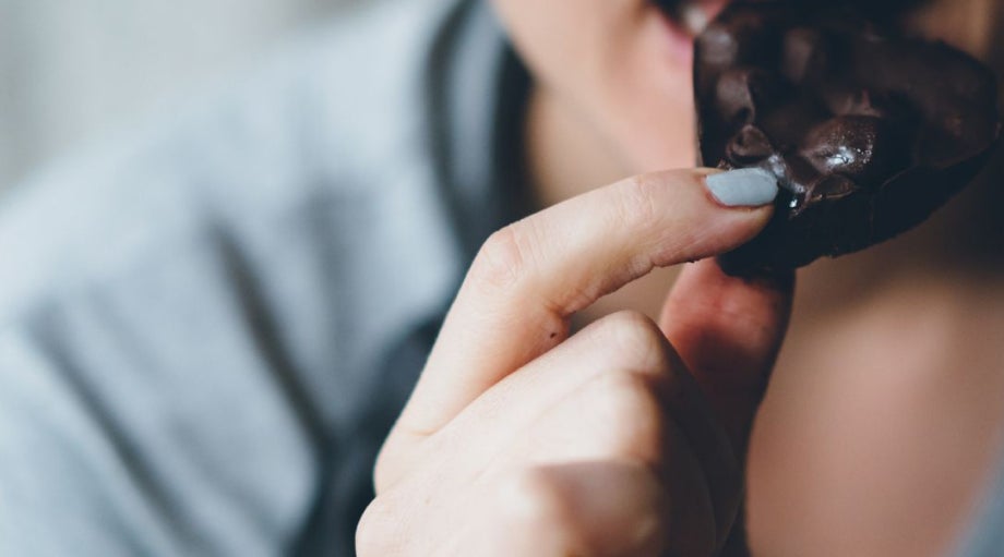 Person enjoying Lily O'Brien's chocolates, representing the brand's indulgent experience