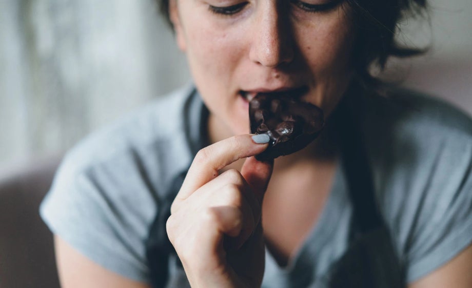 A young woman eats her favourite chocolate