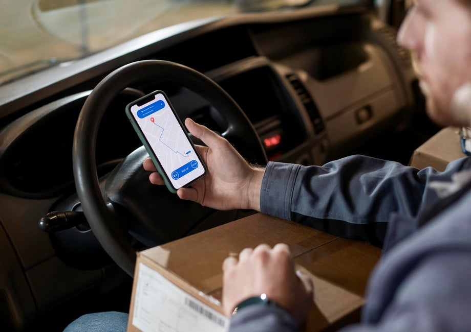 Delivery driver checking a location on his phone