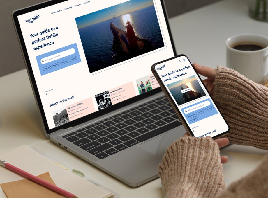 A person visits the Visit Dublin website on their phone and laptop