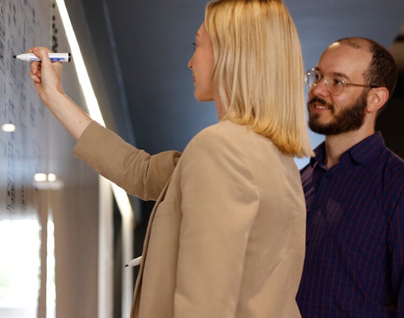 All Human team collaborating at a whiteboard