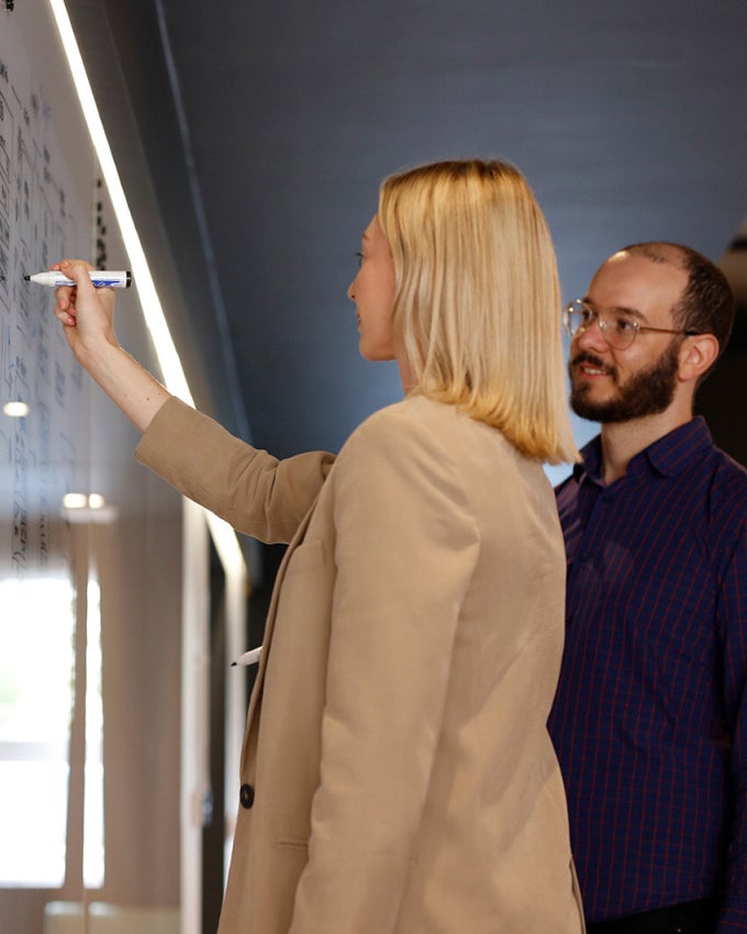 All Human team collaborating at a whiteboard