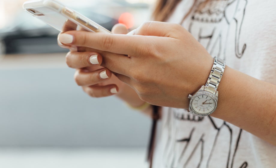 A person holds a smartphone in both hands