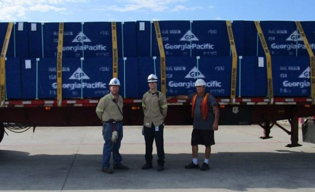 From left to right: Matthew Bynog (Shipping Coordinator), Jon Cook (Production Manager), Truck Driver delivering the shipment.