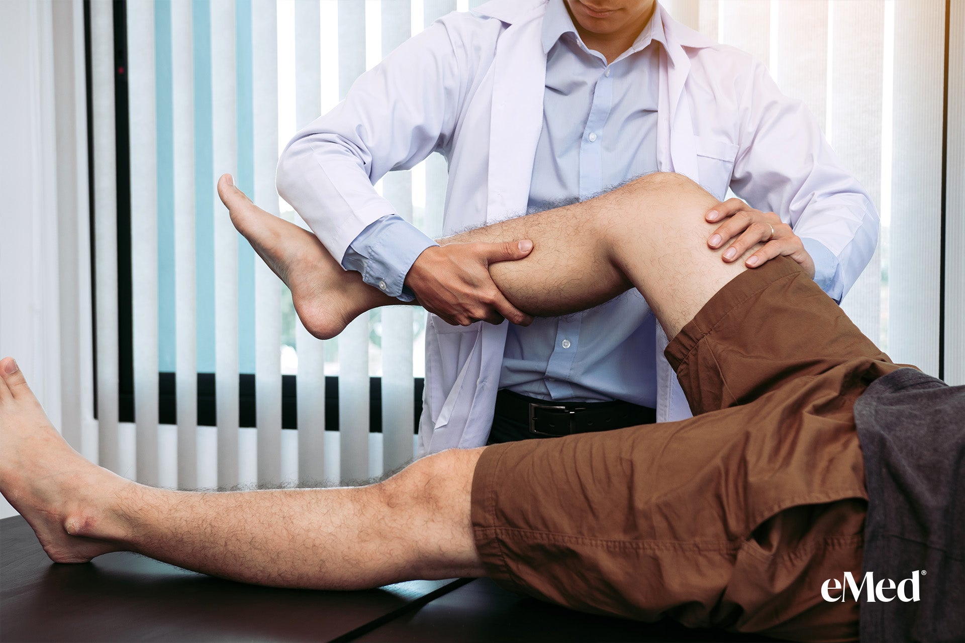 Physiotherapist performing manual therapy massage on a patient's knee