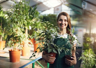 business owner holds plants