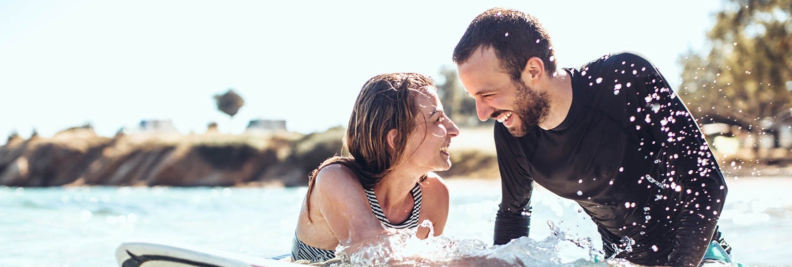 Two people surfing look at each other