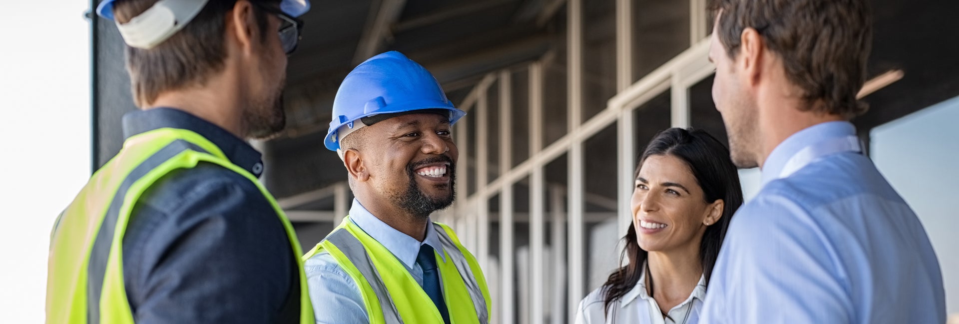 Workers in hard hats shake hands