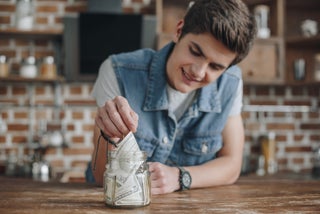 Teen puts bills in savings jar