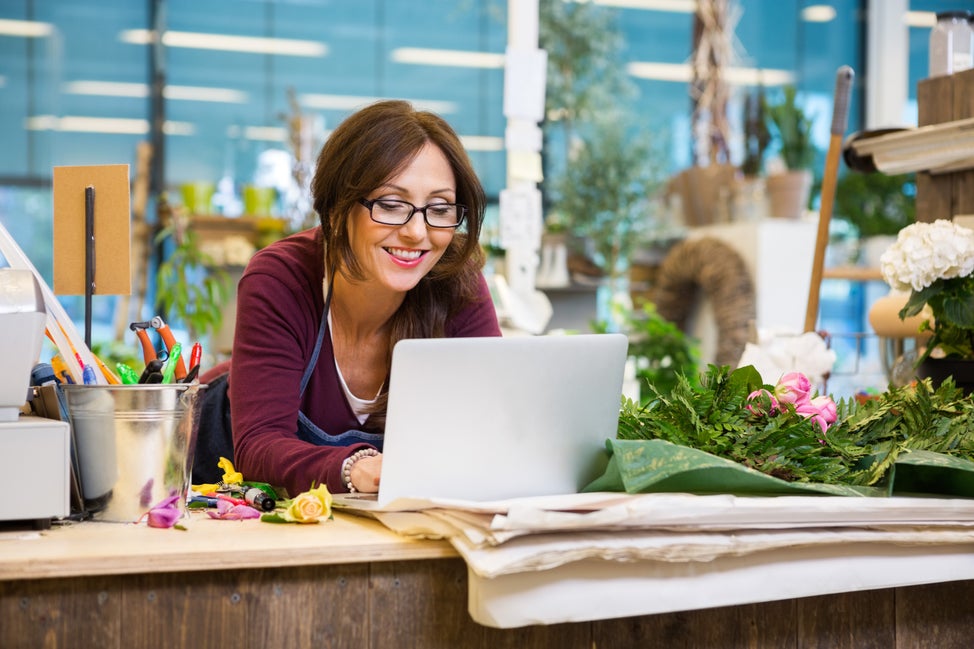 Business owner on computer in flower shop