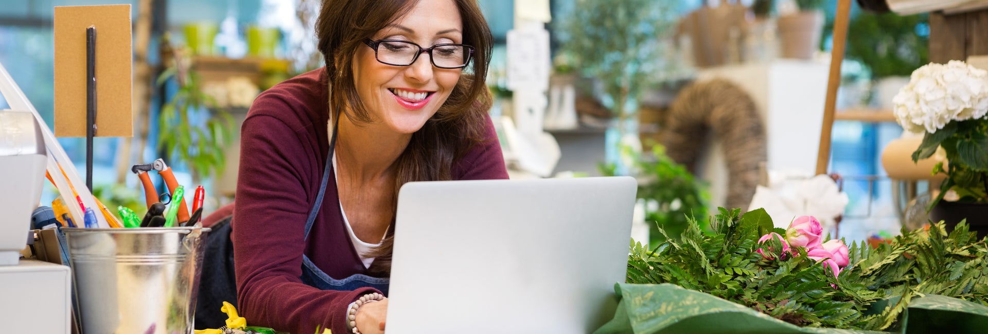 Business owner on computer in flower shop