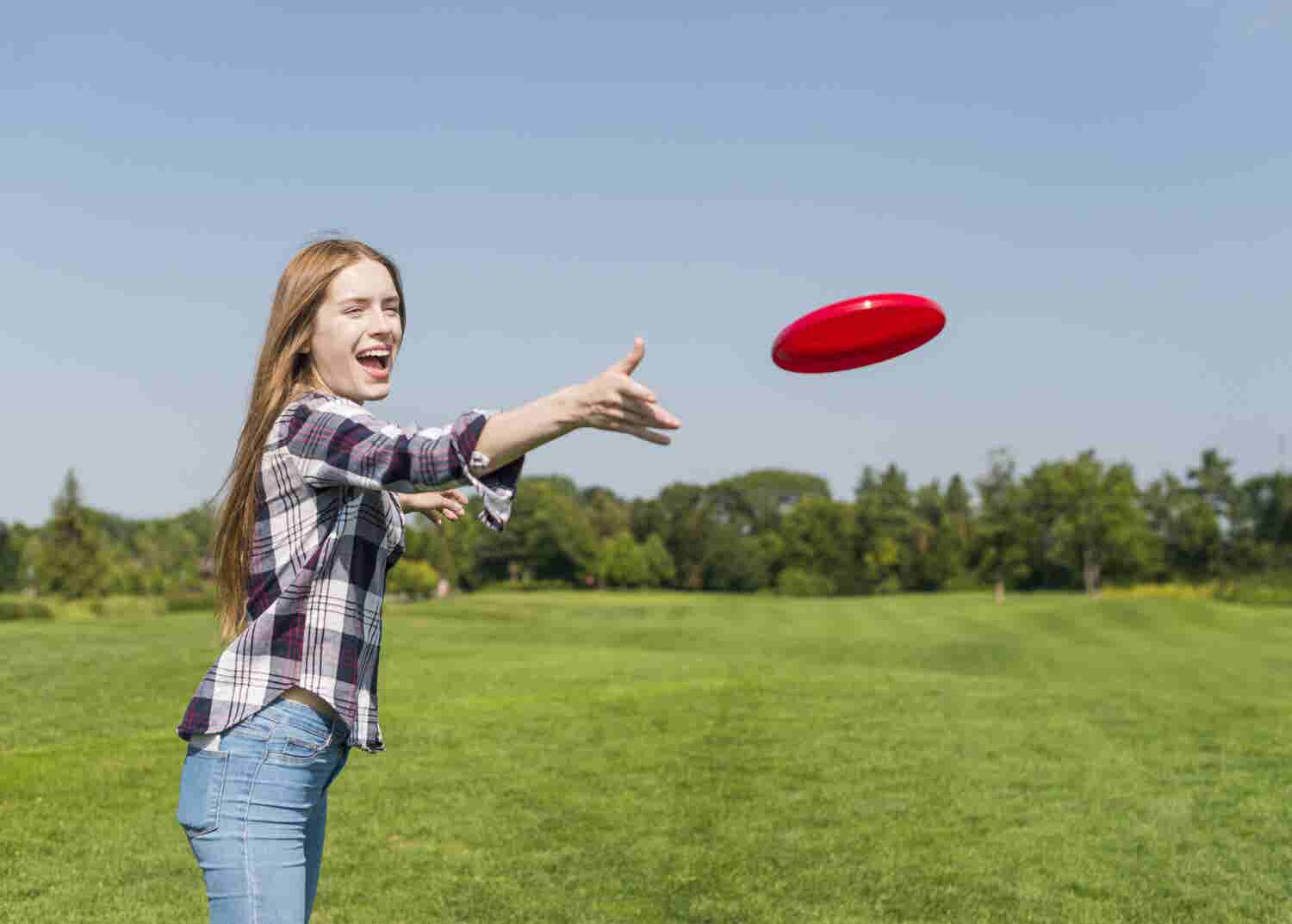 Girl throws frisbee to a friend