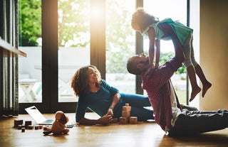 Family plays together on wood floor