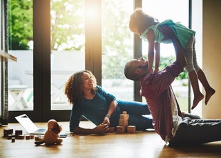 Family plays together on wood floor