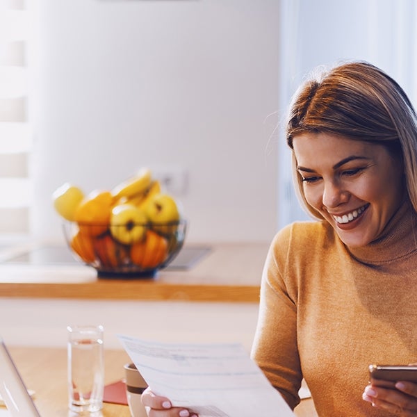 Woman looking at statement smiling