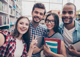 Group of students in pose for photo in library