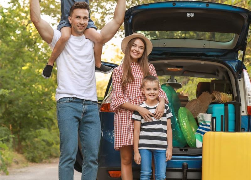 Family with new car on vacation