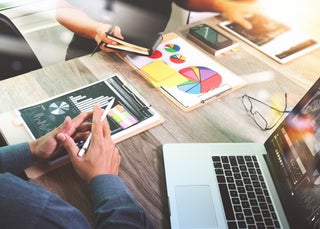 Customers look at financial charts and graphs