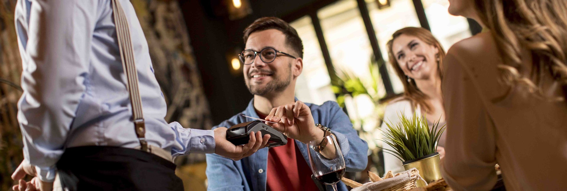 Man pays for meal at a restaurant